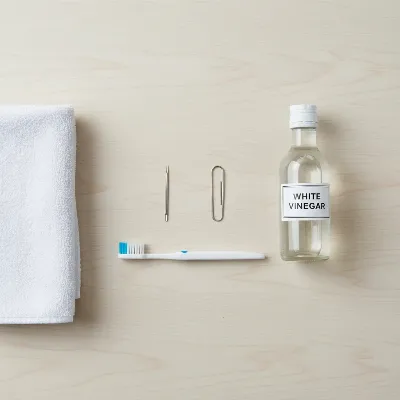 Assortment of DIY tools for unclogging a carpet cleaner nozzle